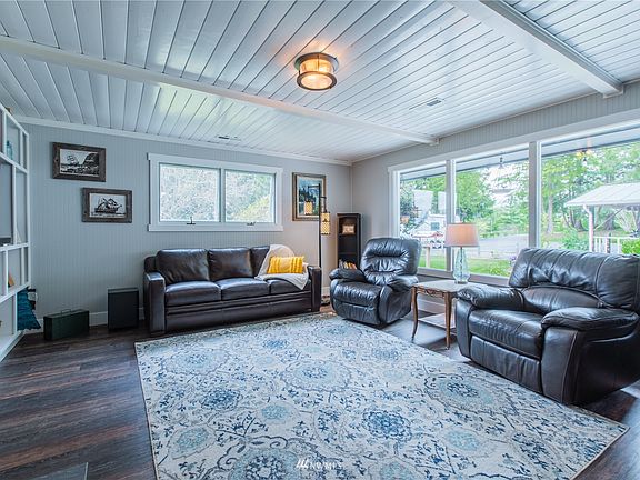 Large living room with Luxury Vinyl Plank floors and large windows
