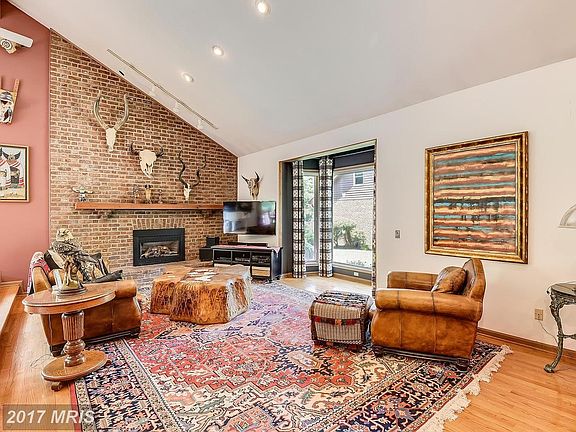 Vaulted Great Room Showcasing Gathering Fireplace
