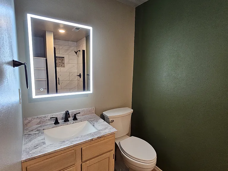Lower level bathroom with lighted mirror.
