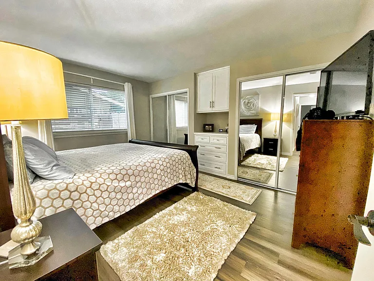 Master Bedroom with dual closets built center wall units