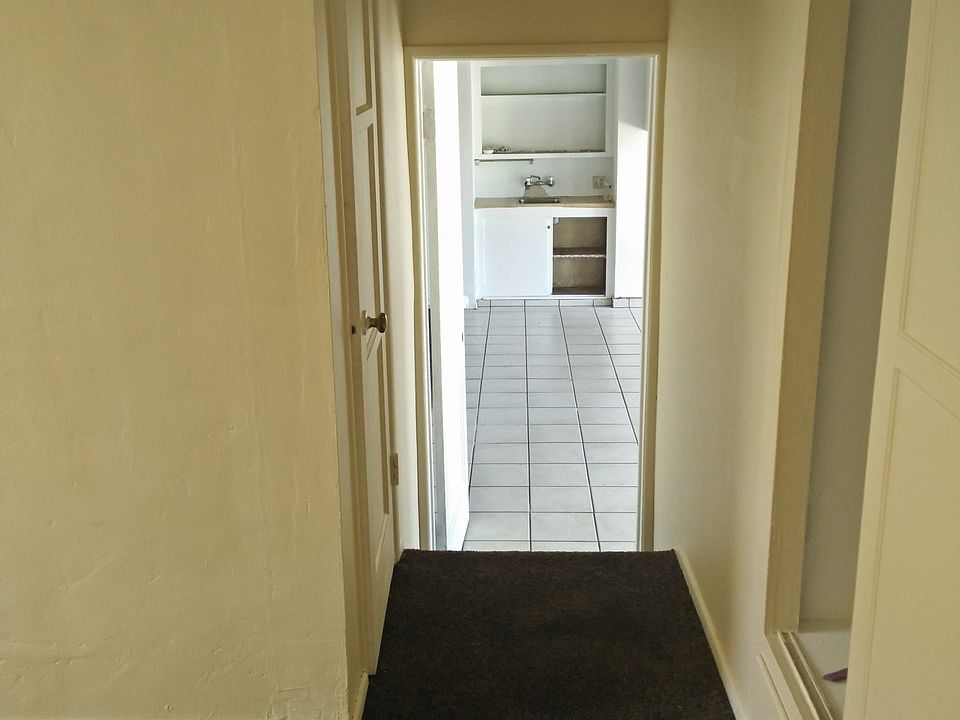 One bedroom leading to living room, small kitchen, dining ar