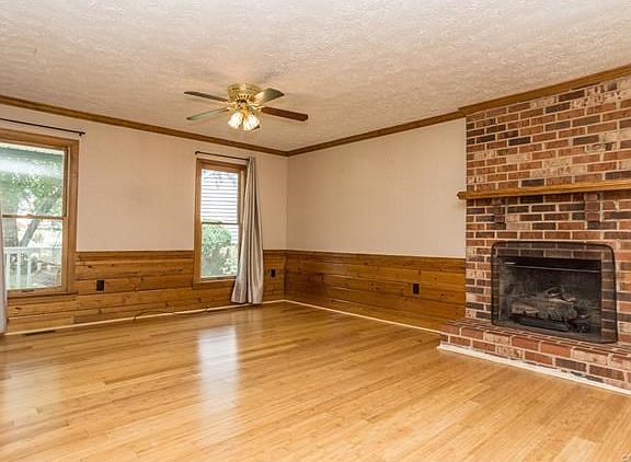 Family room w/brick gas fireplace and 2 ceiling fans.