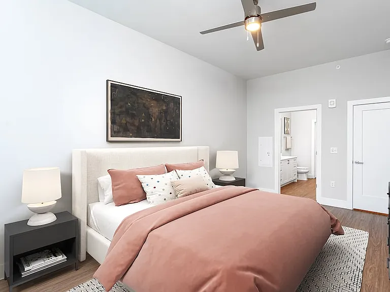 Primary bedroom with ceiling fan and hard-surface vinyl plank flooring