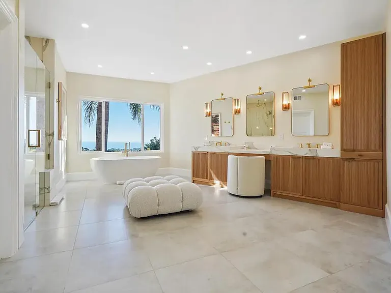 Master bathroom suite featuring large mirrors, dual sinks, and a powder area.