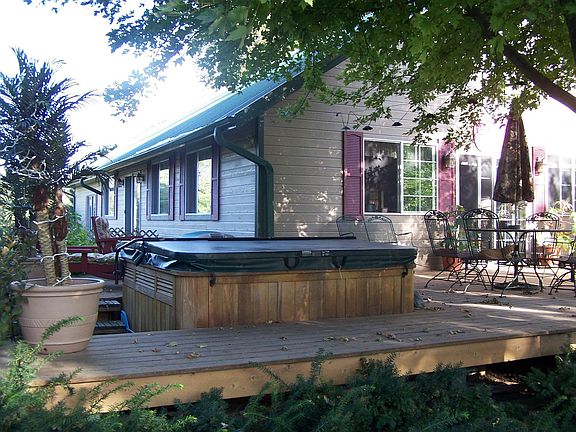 Backside of house with hottub on deck