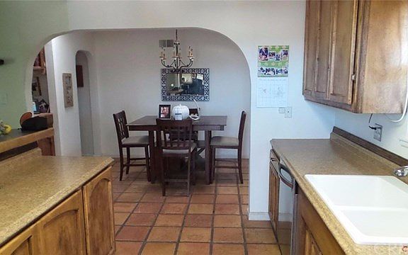 Remodeled kitchen open to dining room. Off to the right of dining room is the family room with fireplace.
