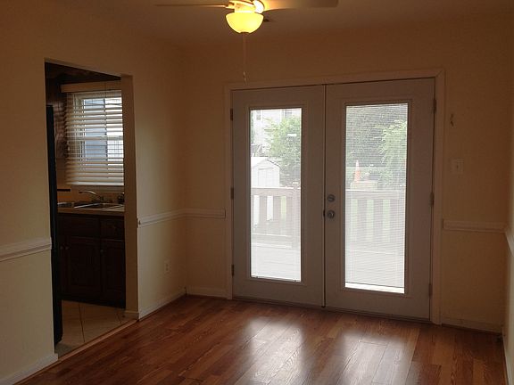 Family room with doors to deck and back yard; kitchen entry