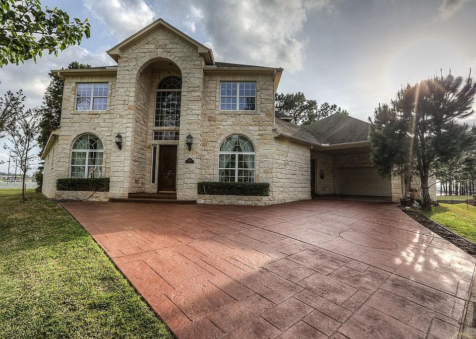 This home is wrapped in stone on all four sides. Stained concrete driveway was recently re-done.