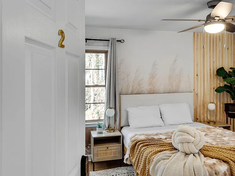 The styled bedroom with two windows: Two windows, one view: wake up to the creek every morning.