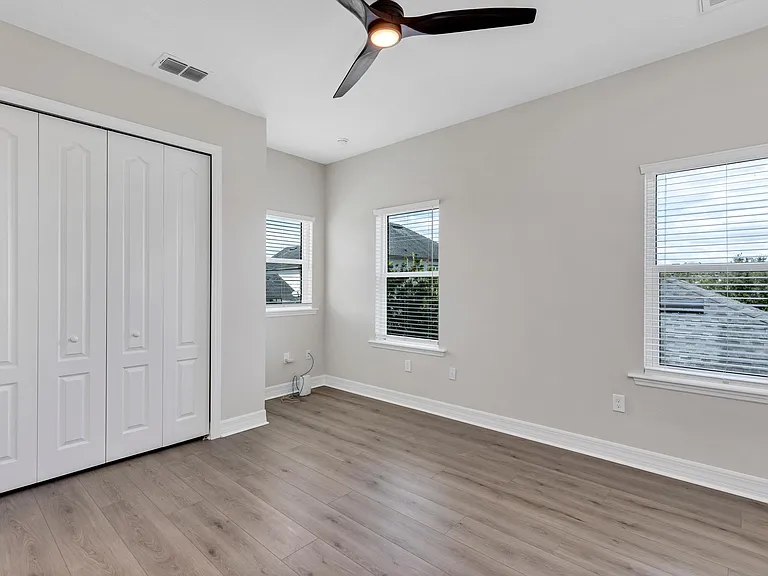Bedroom view facing north east with view of closet with doors closed.