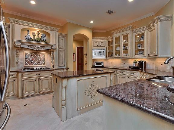 This light and bright gourmet kitchen has it all with top stainless steel appliances and high end granite countertops-