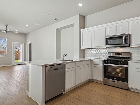 Kitchen in the Birch home plan by Trophy Signature Homes - REPRESENTATIVE PHOTO