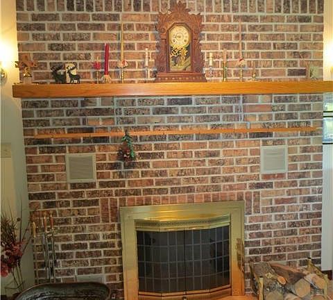 Brick fireplace with oak custom made mantel