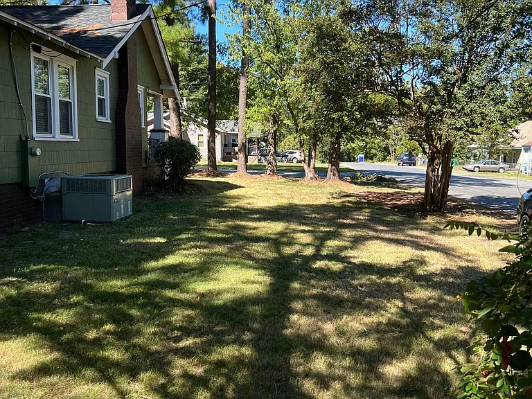Side yard, this home sits on a .17 acre corner lot.
