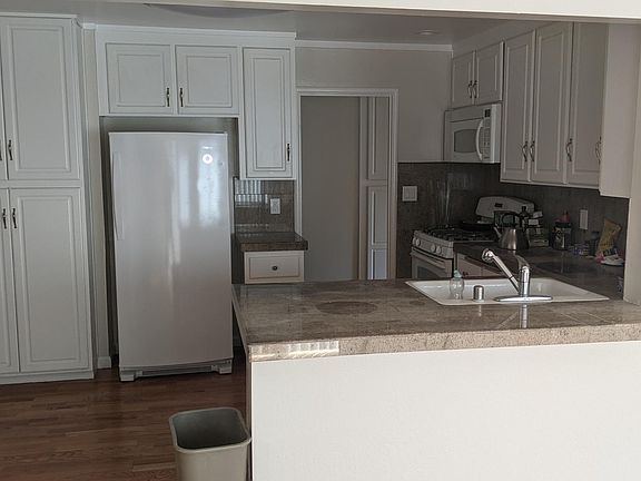 kitchen is central hub in middle of house. Counter to dining room/family room.