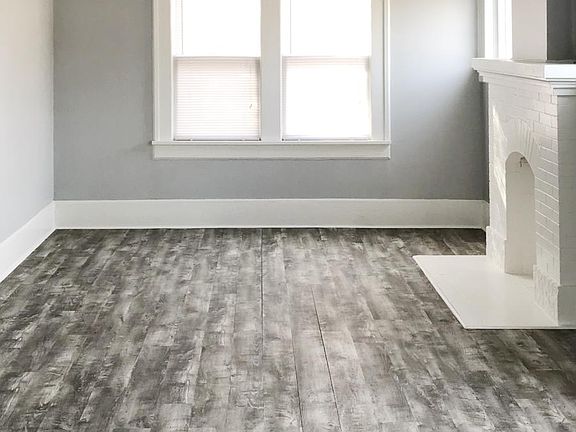 Living room featuring lots of windows, new flooring, and new