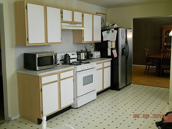 Another view of the kitchen.  Seller to tile kitchen floor before sell.