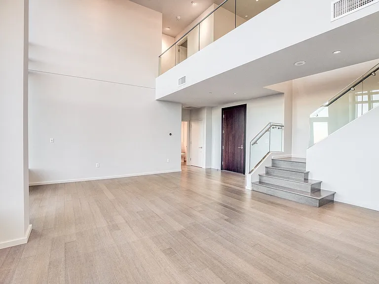 Open concept penthouse with hardwood flooring