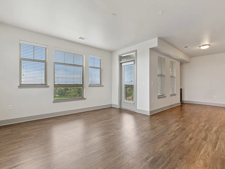 Open concept floor plan with high ceilings and oversized windows