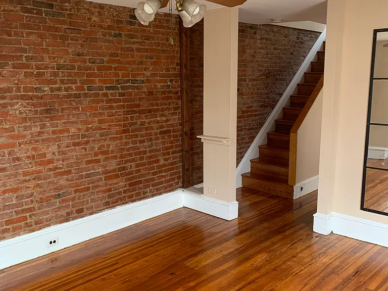 Living area with exposed brick wall and plenty of natural light