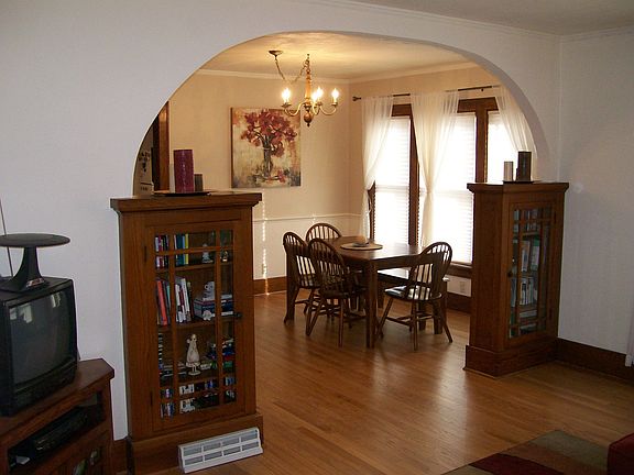 Dining Room viewed from living room archway with built-in windowed cabinets.