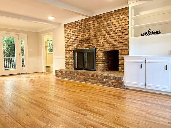 Family Room has a 1/2 wall of built-ins with the other 1/2 wall a masonry fireplace with wood storage area