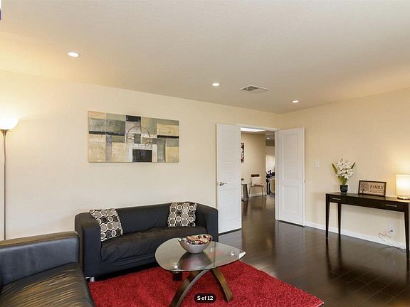 Living Room with lots of natural light (Floor was dark brown when we bought it, the floor has been refinished so that home feels more bright)