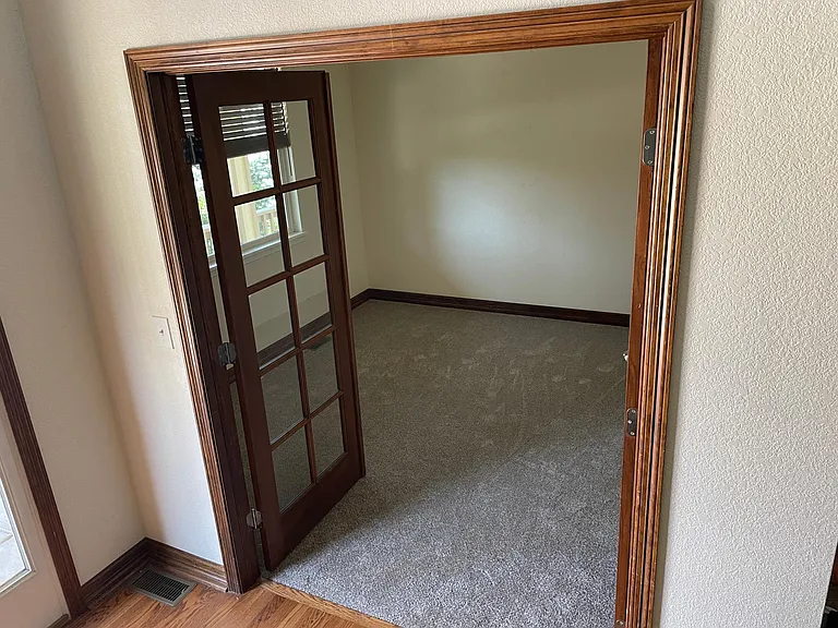 An office with french doors is right after you enter the home