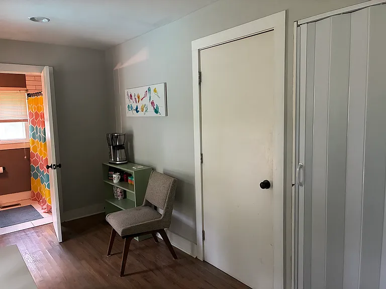 Private sitting area, bathroom and bedroom are separated from the rest of house by doors.