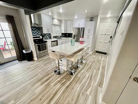 Open kitchen with island to living room and patio