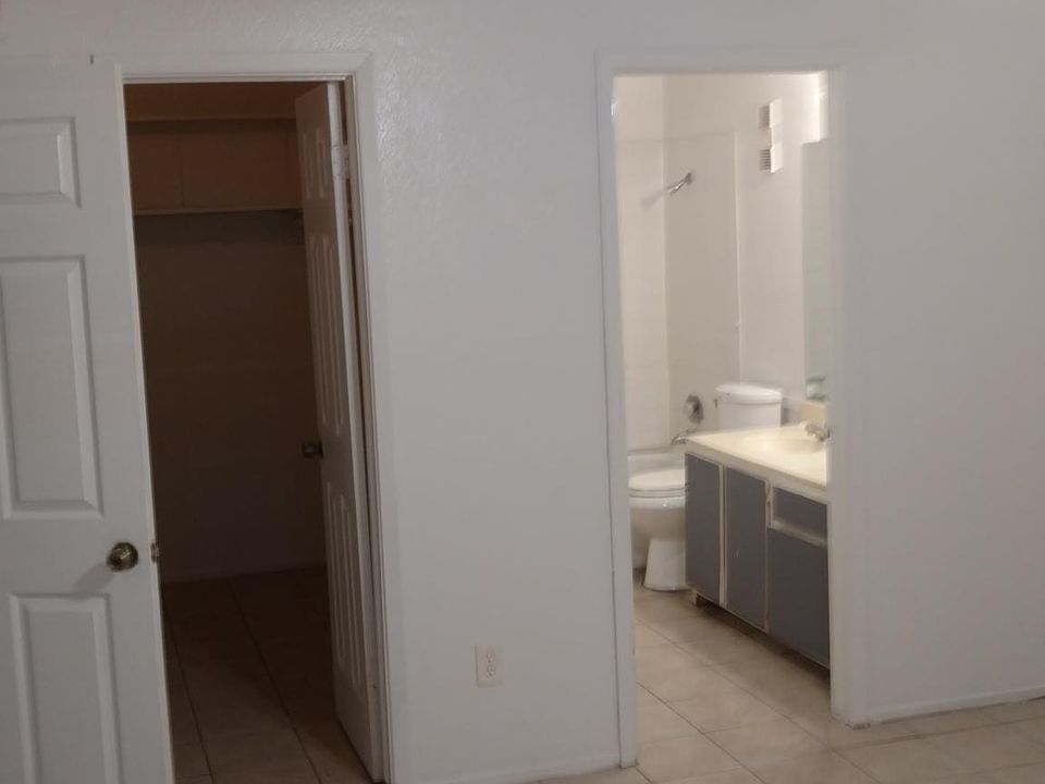 Bedroom looking at walk in closet on left, and bathroom on r