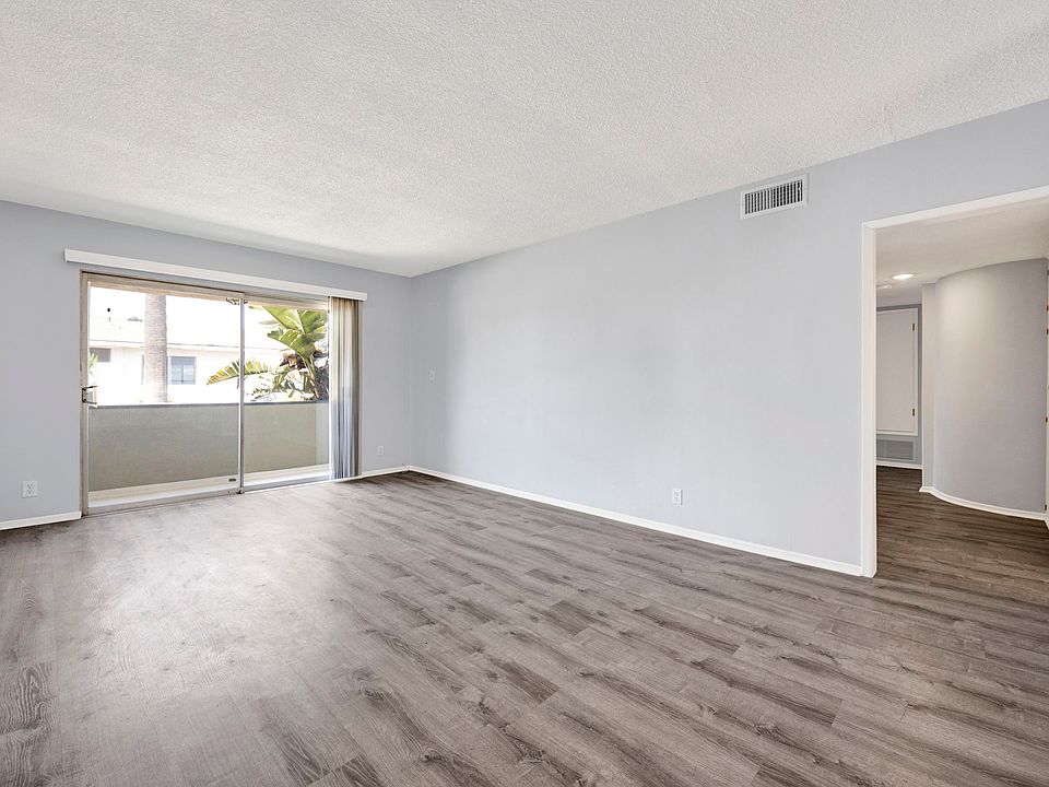 Living room with view of balcony and hallway