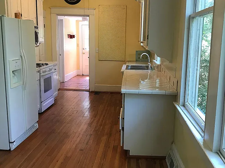 Kitchen and hallway. Down BR on left and laundry/half bath on right.