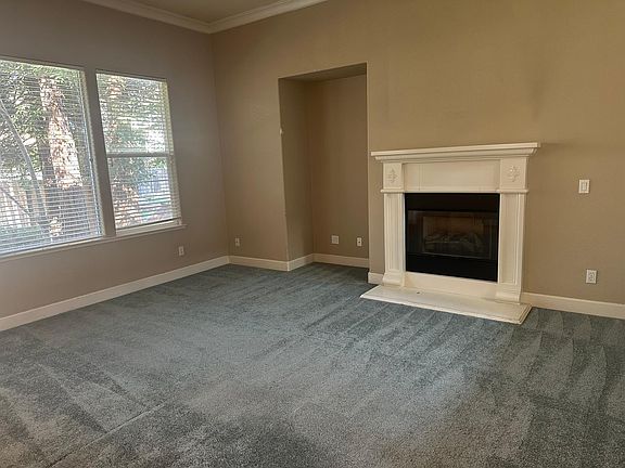 Family room with ceiling fan & gas fireplace.