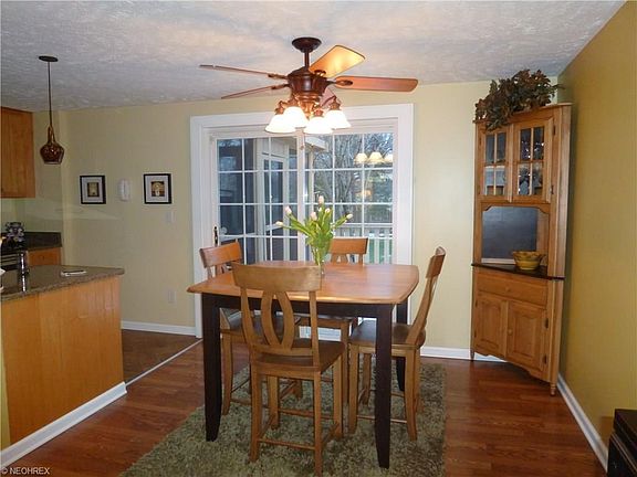 FORMAL DINING ROOM FEATURES TOP GRADE PERGO WOOD FLOOR, SLIDING DOOR TO WOOD DECK AND SCREENED IN PORCH