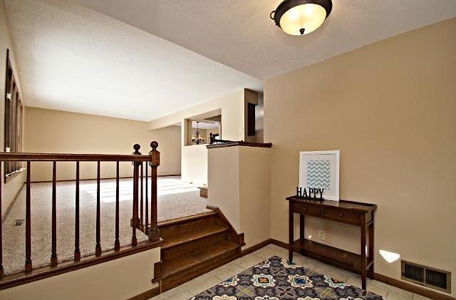 Inviting, large entry with double doors, newly tiled floors and large closet give guests an welcoming feeling.