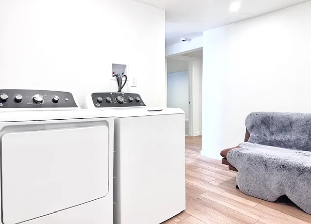 Private entrance. Luxurious seating area with wall art. Brand new washer & dryer.