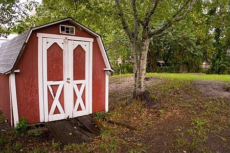 Large fenced yard with Storage shed