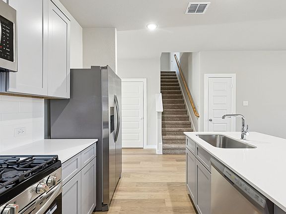 Kitchen in the Haylee home plan by Trophy Signature Homes - REPRESENTATIVE PHOTO