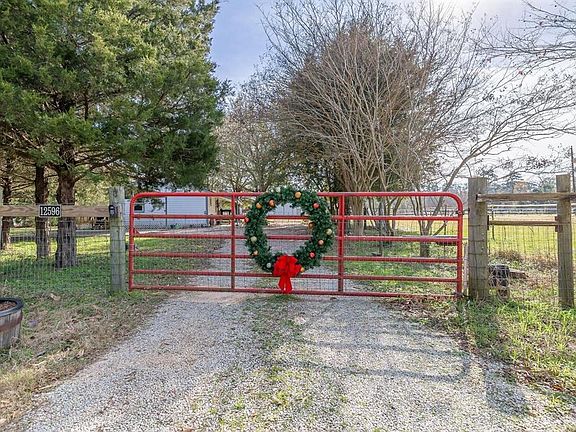 The electric gate greets you home as you turn off of Chandler Lane. Gate comes with 3 remotes.
