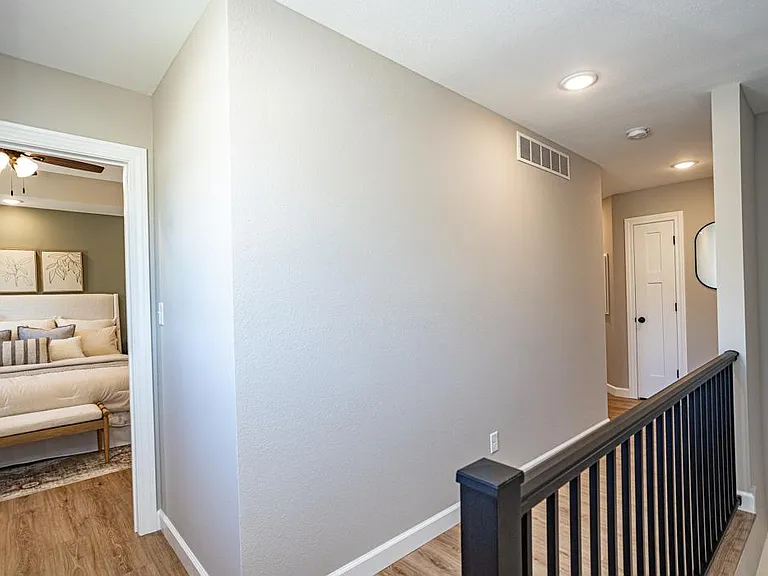 hallway leading to additional bedrooms, bathroom and utility room