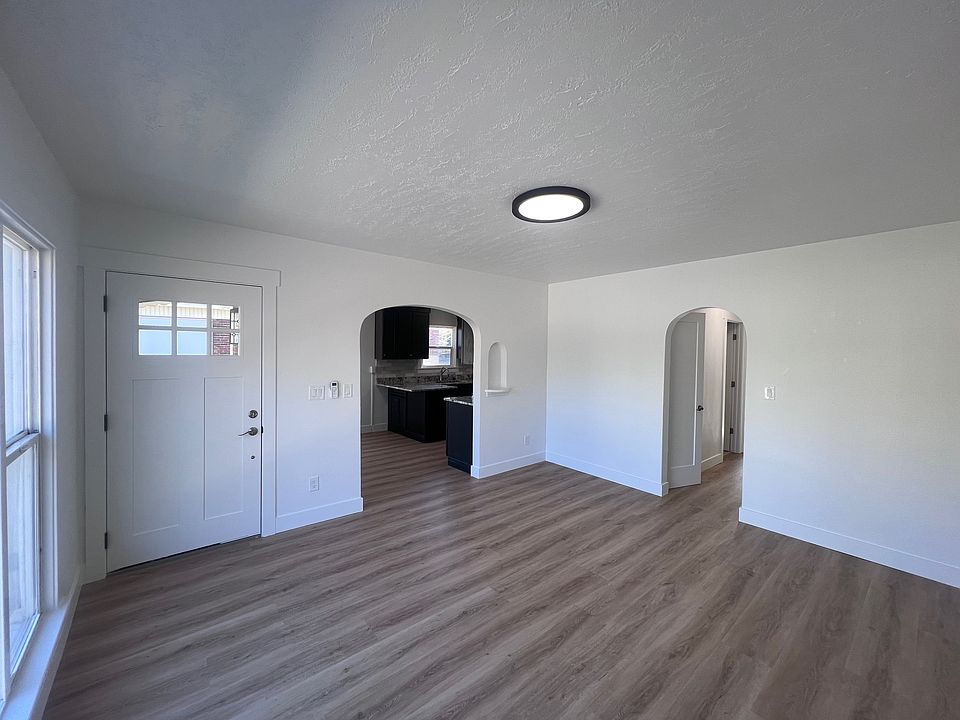 Living room with a front door. The unit has two entrances: one through the living room and another through the kitchen, which leads to your dedicated parking spot.