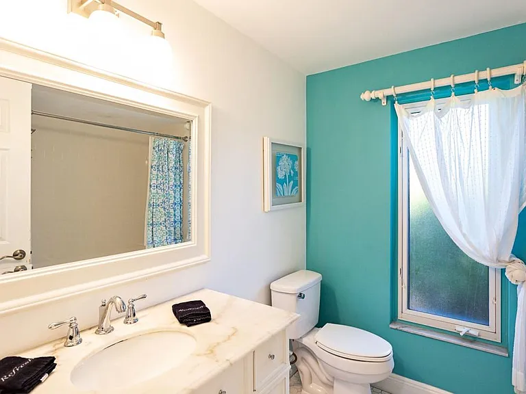 Second bathroom with view of window