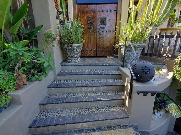 Steps to front door with closed gate.