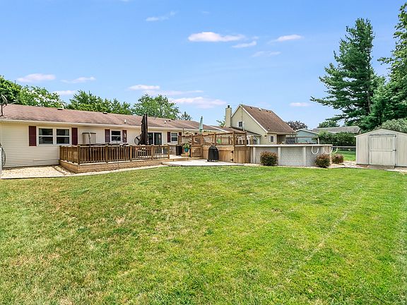 Backyard oasis with pool, deck, and shed!