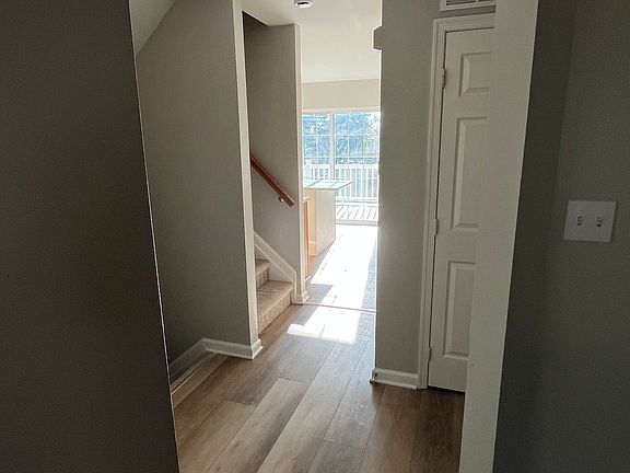 Hallway from Family Room to Half Bath, Garage, Stairs, and Kitchen