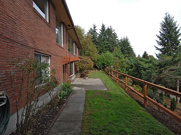 Side view of lower level showing sprawling yard with picket fence