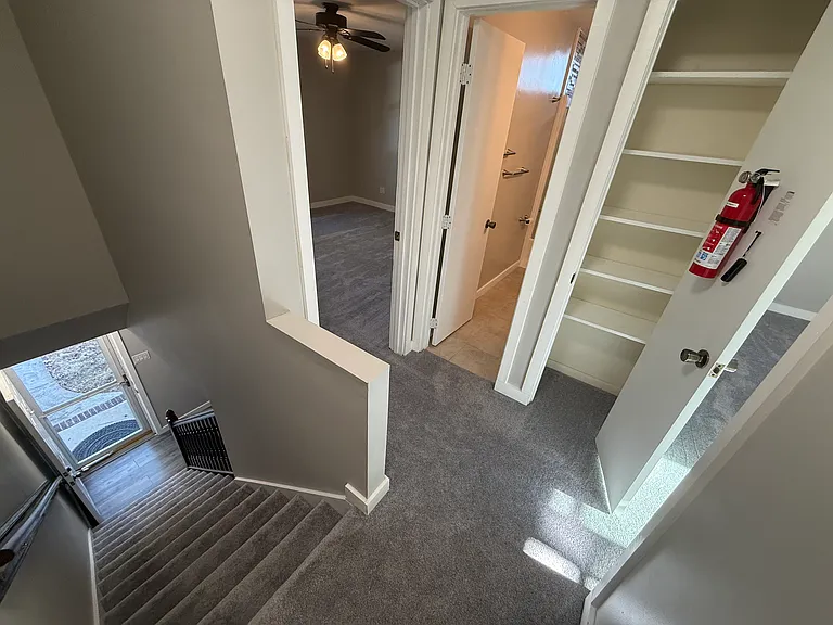 Upstairs view of door, linen storage closet, bathroom, front bedroom
Brushed nickel door fixtures