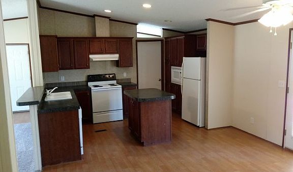 Kitchen with built in island. Appliances include stove, dish