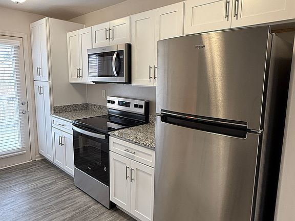 Kitchen featuring granite countertops, soft close cabinetry, stainless steel appliances